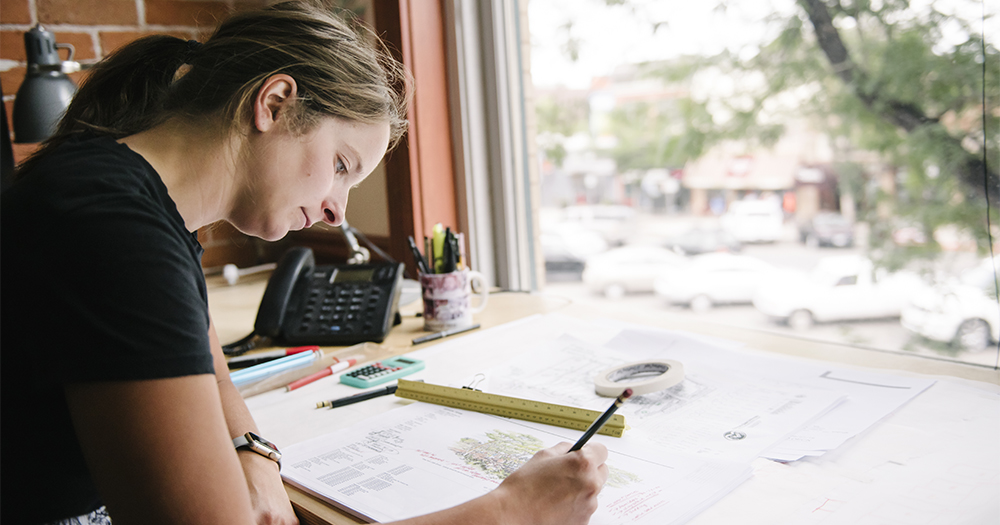 girl studing and drawing at a desk