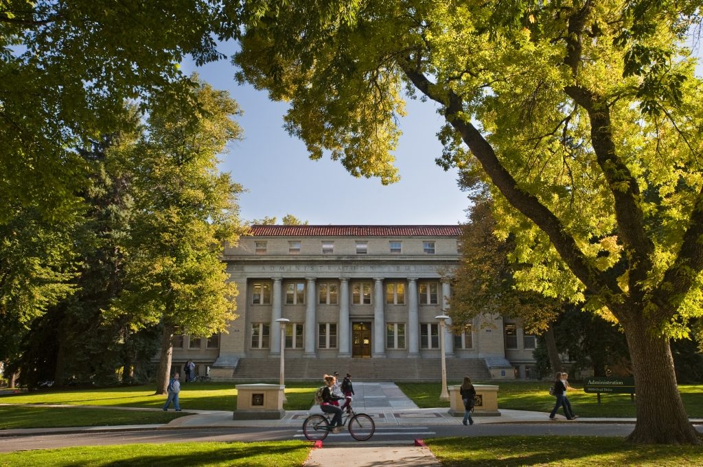 The Administration Building is surrounded by fall leaves on the Colorado State University Oval.
