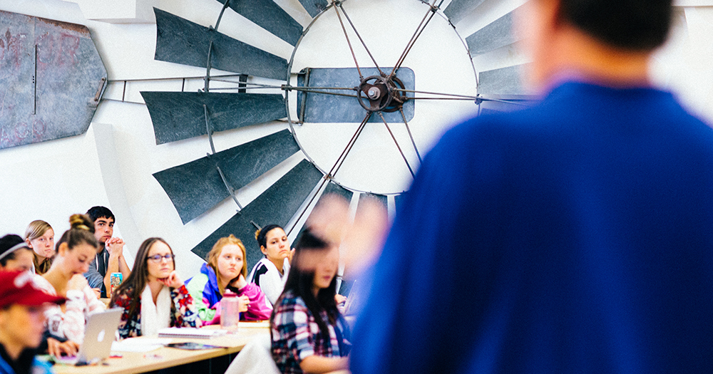 Students listen to a lecture by a professor.