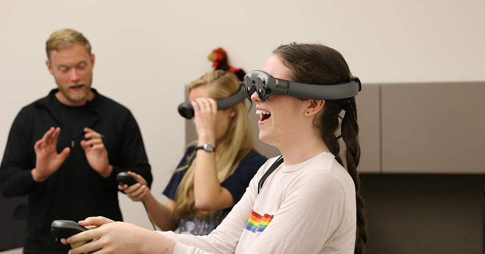 students experiment with a virtual reality device