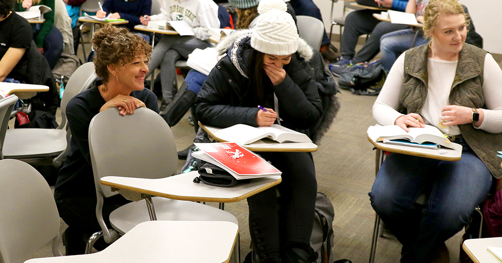 students discuss in a round-table class setting