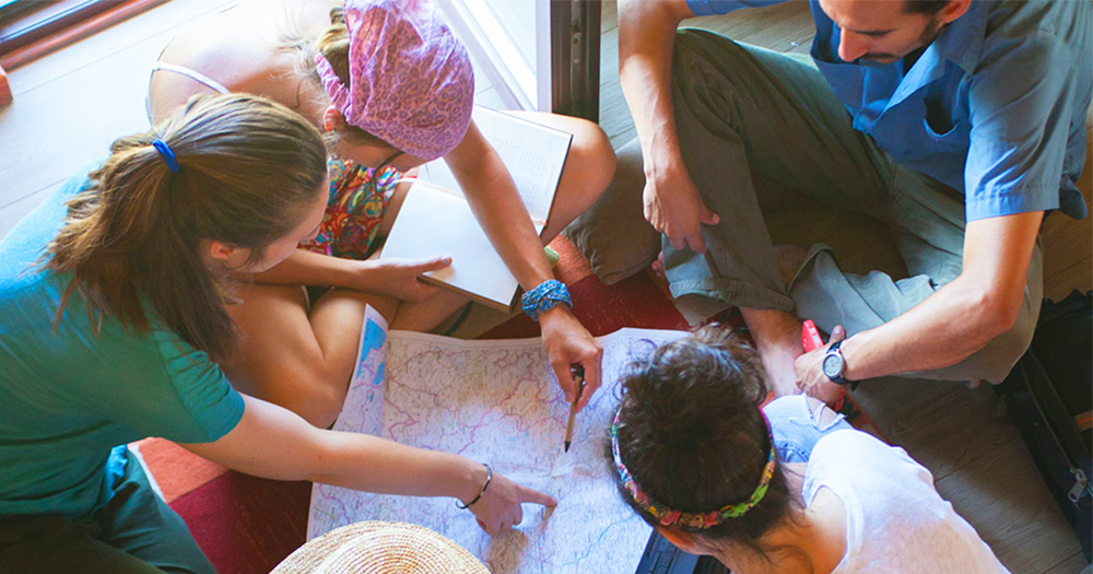 students gather around a map