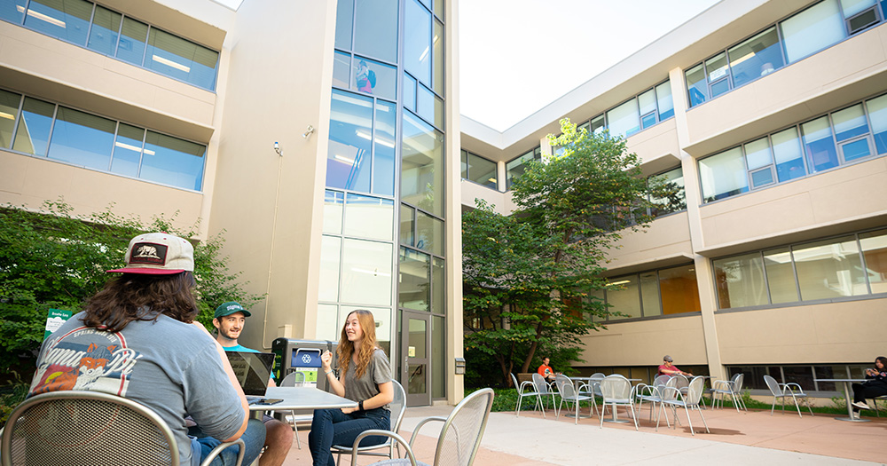 Students sit outside in the courtyard of CSU's Eddy Hall.