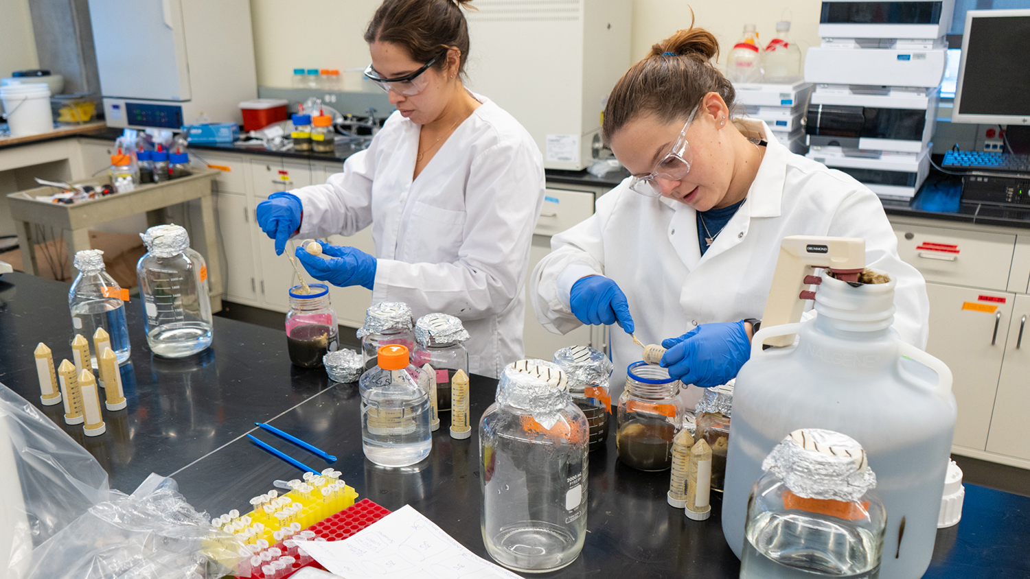 Students work in a lab with environmental elements and tools