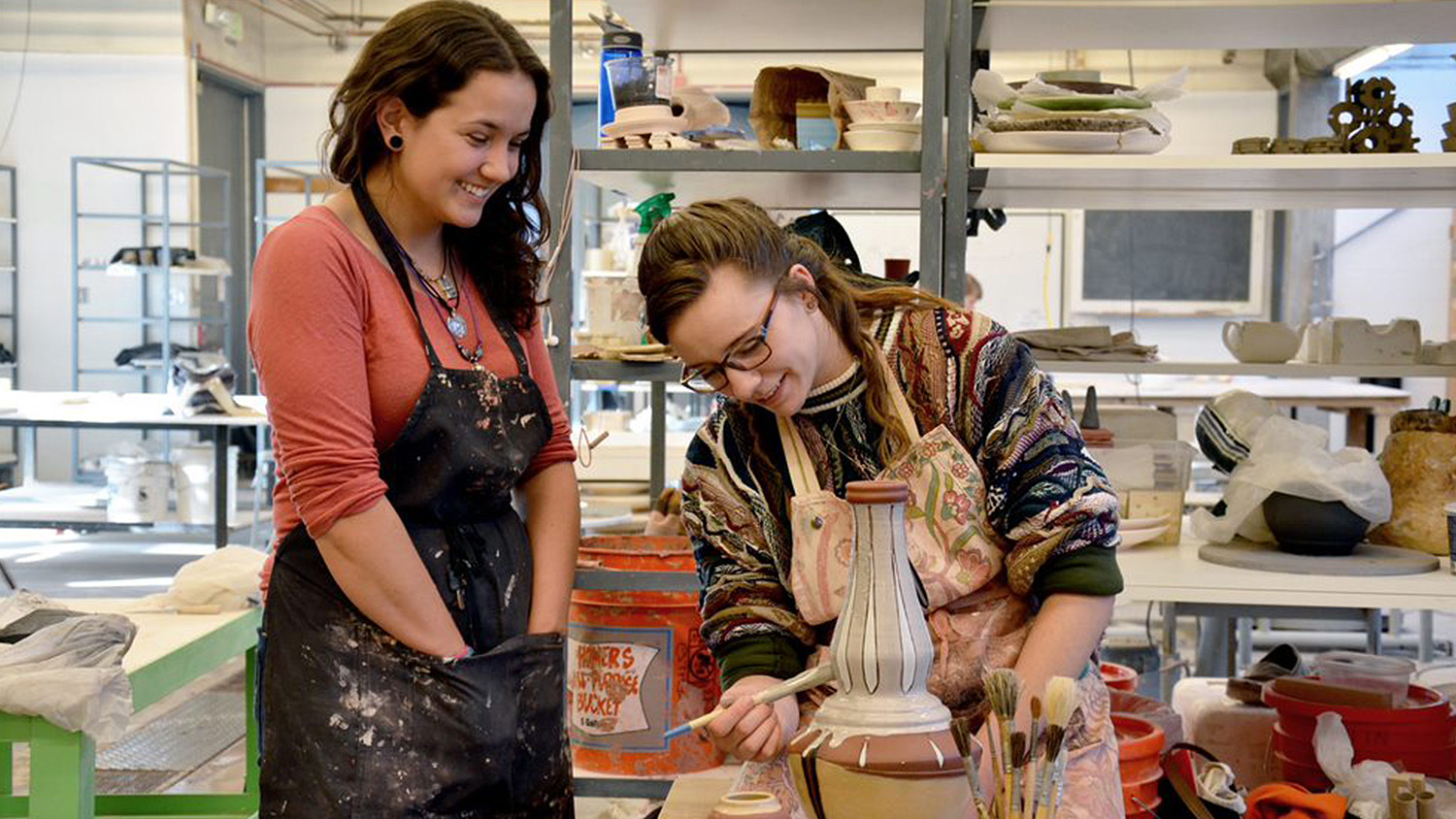 Student work on a vase in the pottery studio