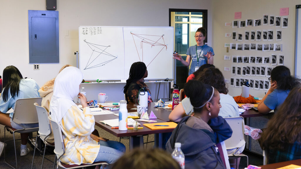 a math professor explains complex diagrams in a class