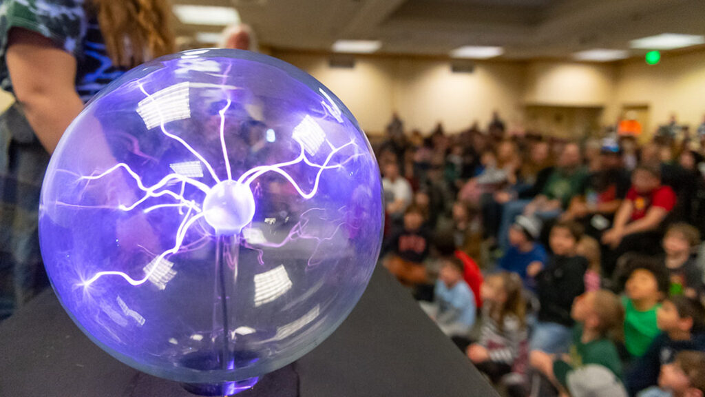 kids watching an electric ball