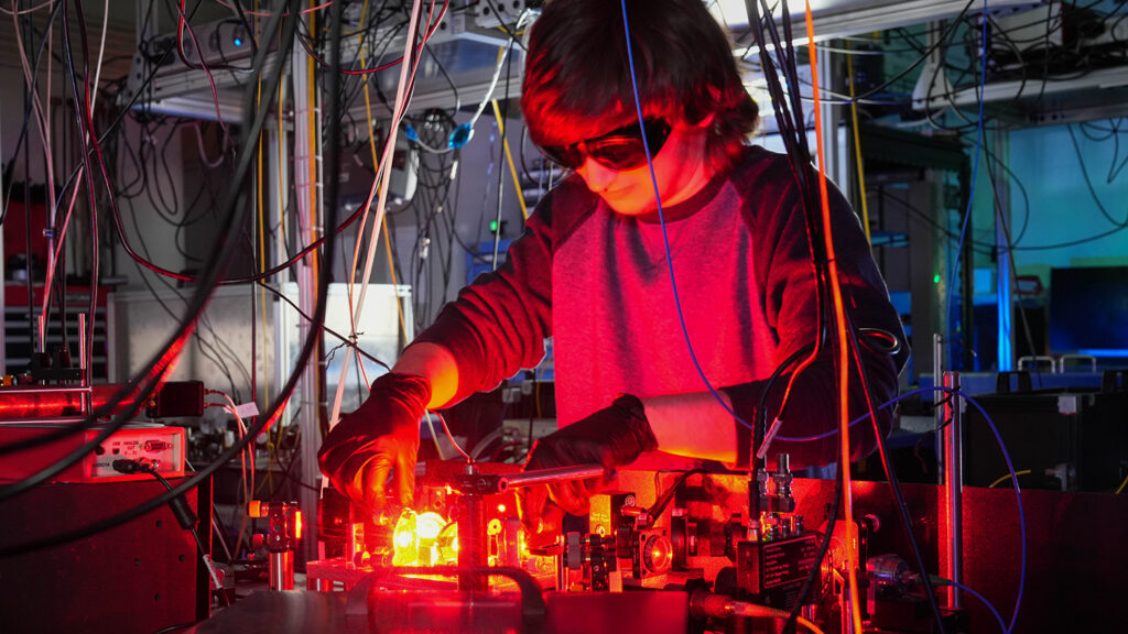 a student works with a red laser