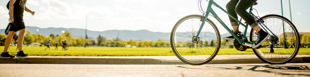 Biking and walking along sidewalk