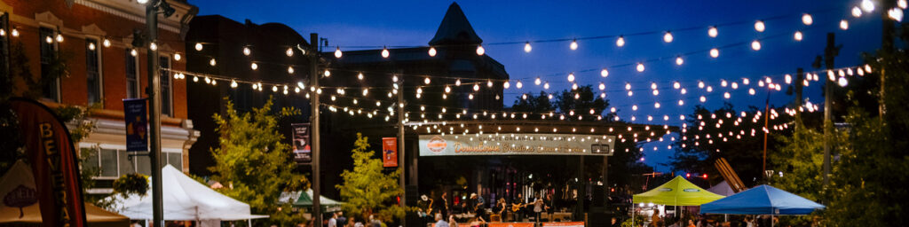 Concert in downtown Fort Collins with lights on at dusk