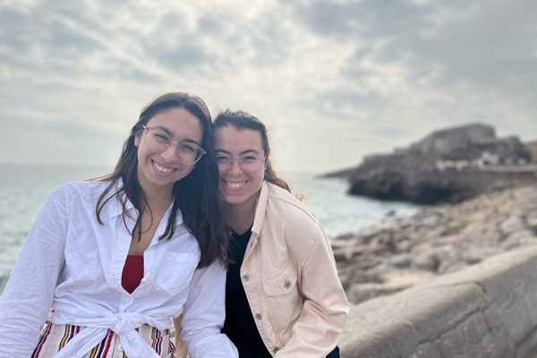 Ames posing with another person on the beach