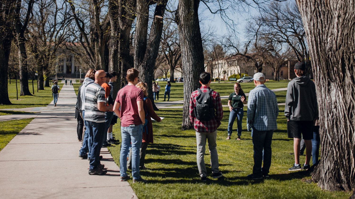 A group of visitors circle up around a tour guide