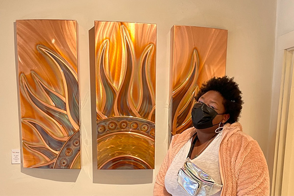 Alexis posing near artwork