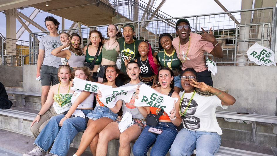 Group of students pose and laugh at the camera