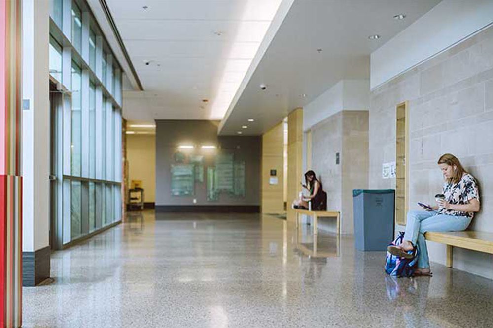 Hallway with students sipping coffee