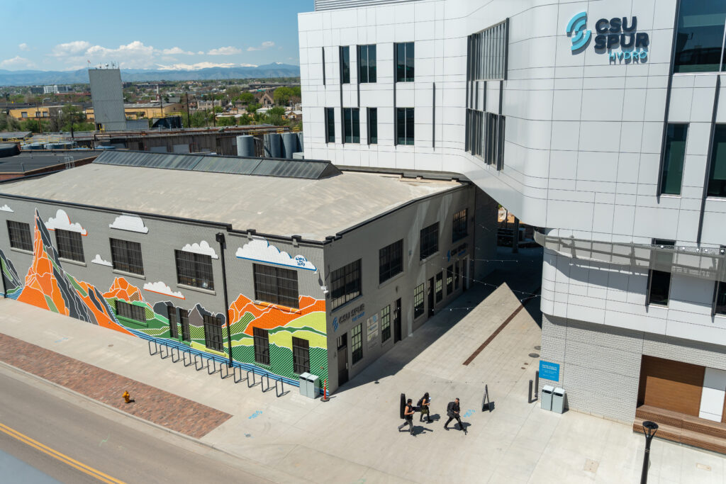 Aerial photo of large buildings and students walking on wide concrete path