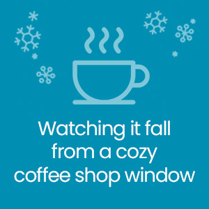 Watching it fall from a cozy coffee shop window