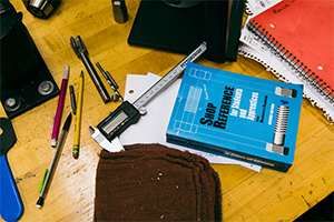 desktop with various mechanical engineering tools