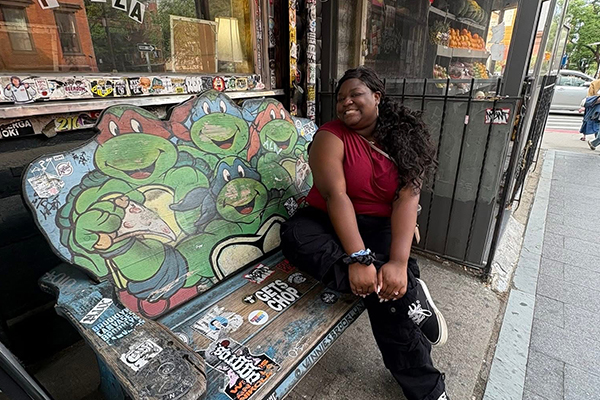 Alexis sitting on a TMNT bench