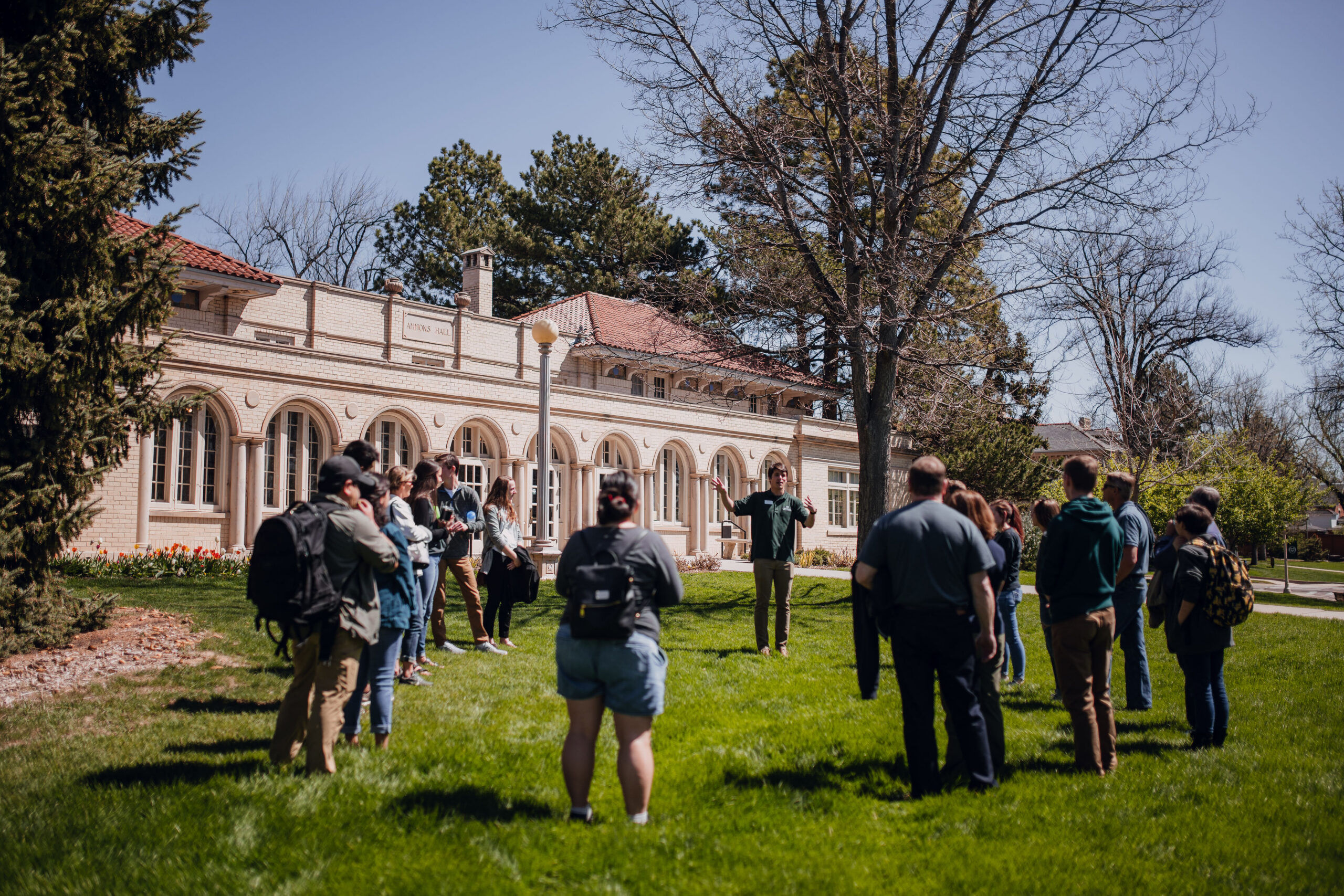 Tour guide giving a tour outside of Ammons Hall at CSU