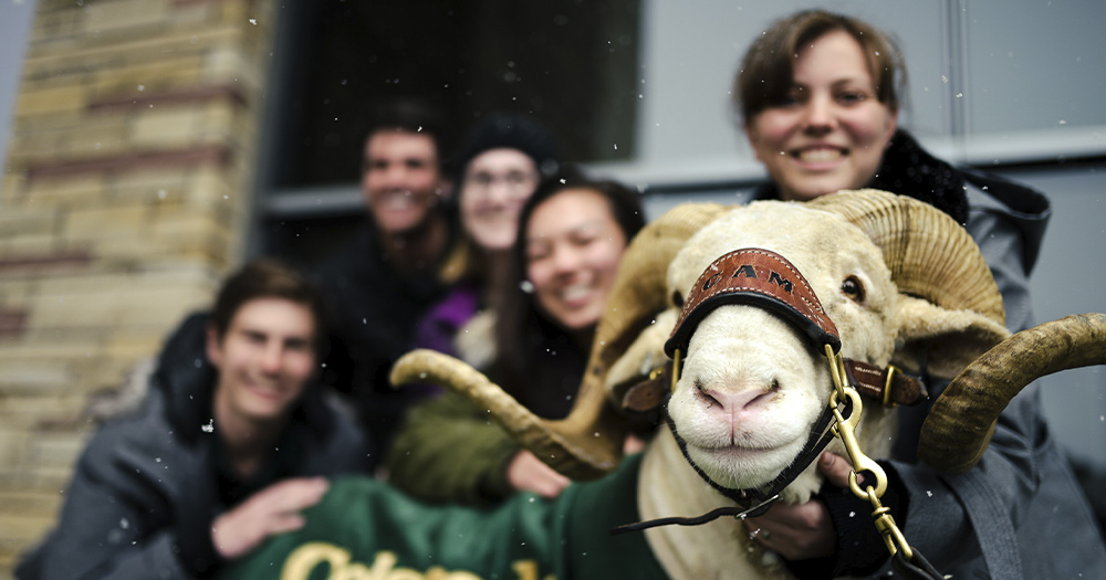 A group of students pose with CAM the Ram.