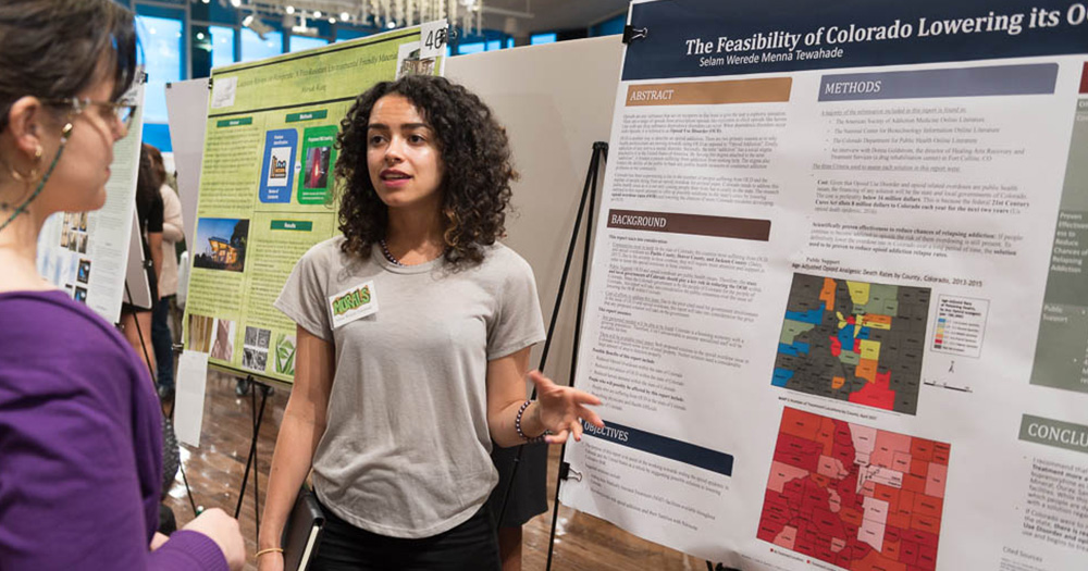 an undergrad presents a research project at a symposium