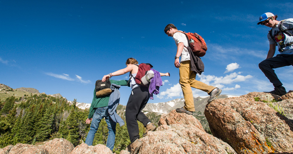 students hike through the Rocky Mountains