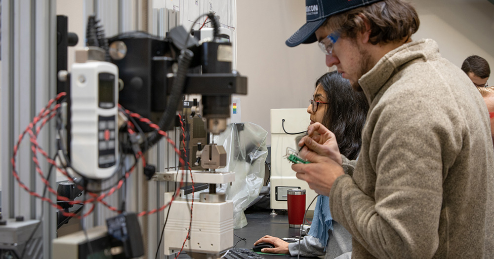 A Colorado State engineering student works with technology in a lab