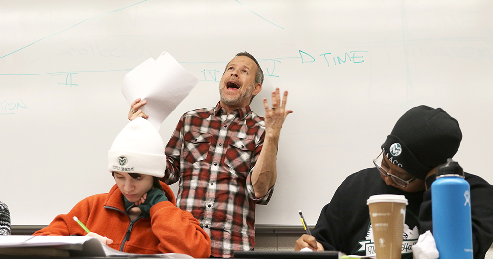 A professor yells in elation during a eureka moment for his students