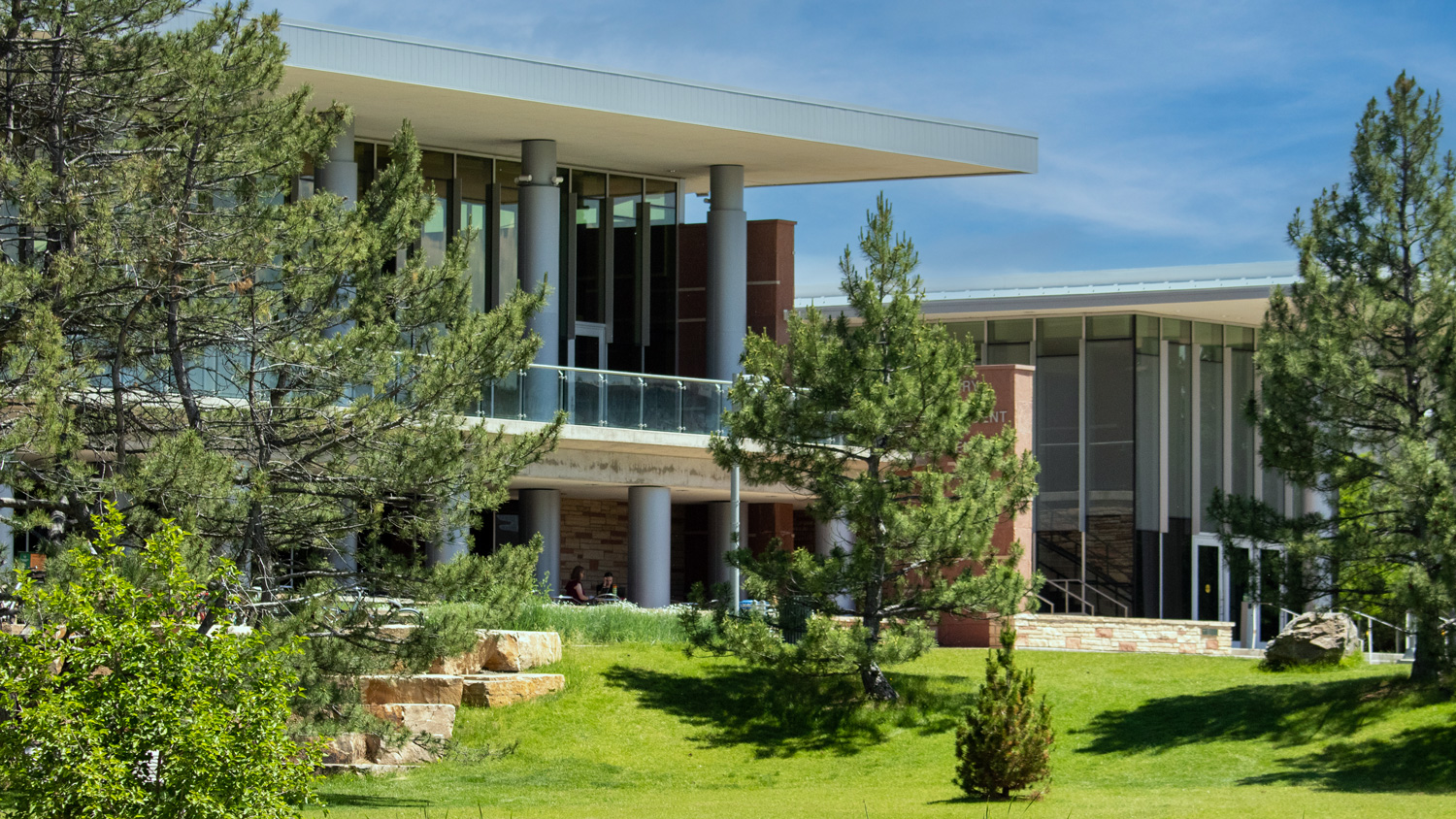 Exterior of student center with lots of trees and grass around