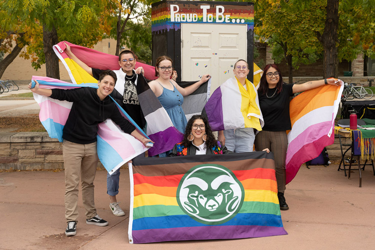 Group of CSU students holding up CSU pride flags