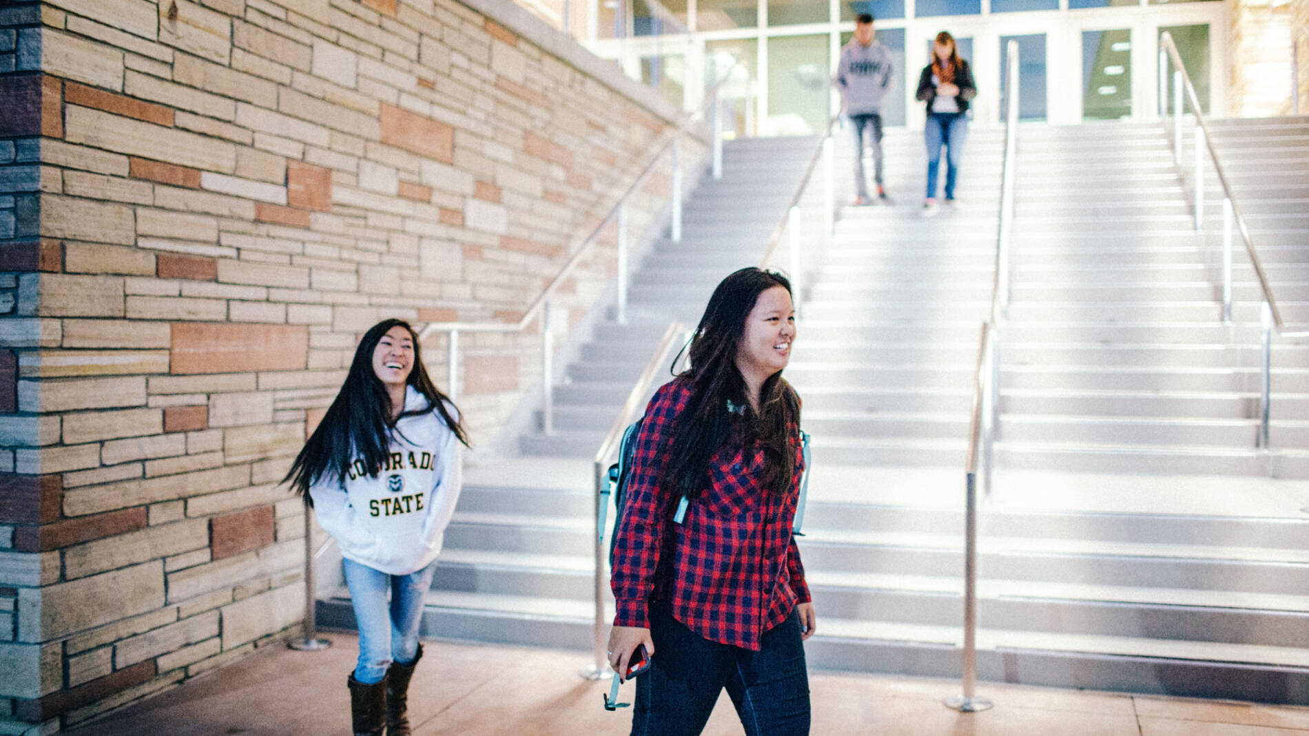 Two Native American students walking down a long set of stairs
