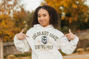 Student points to the CSU logo on her CSU hoodie