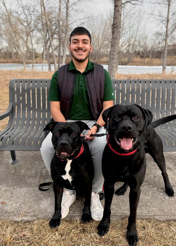 Gabriel posing with his two dogs