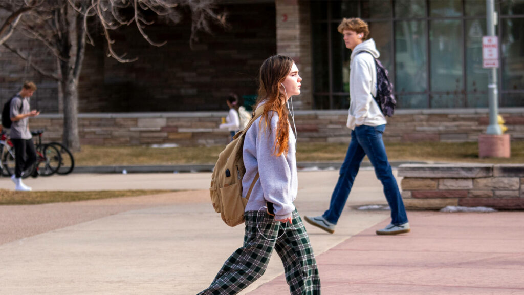 Student walking to class with pajamas on.