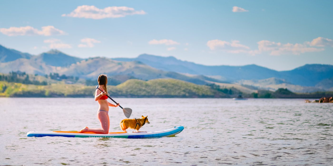 Woman paddleboarding on reservoir